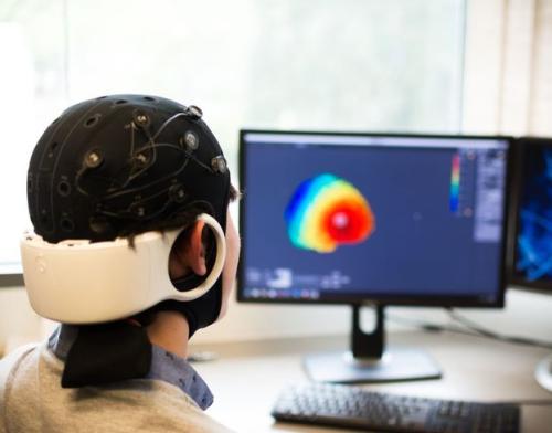 Person sitting with electrode headgear